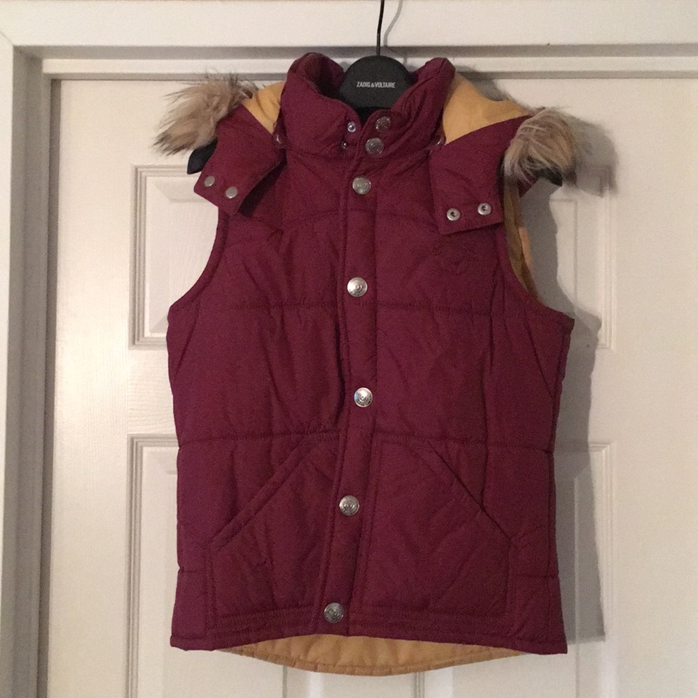 A vest with detachable hood.